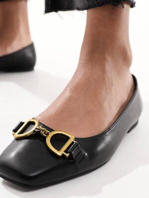Asos solid wide feet flat shoes with gold buckle details in black